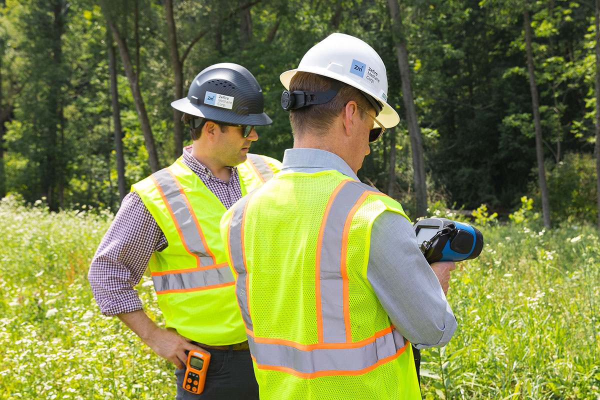 Two men in reflective vests on site
